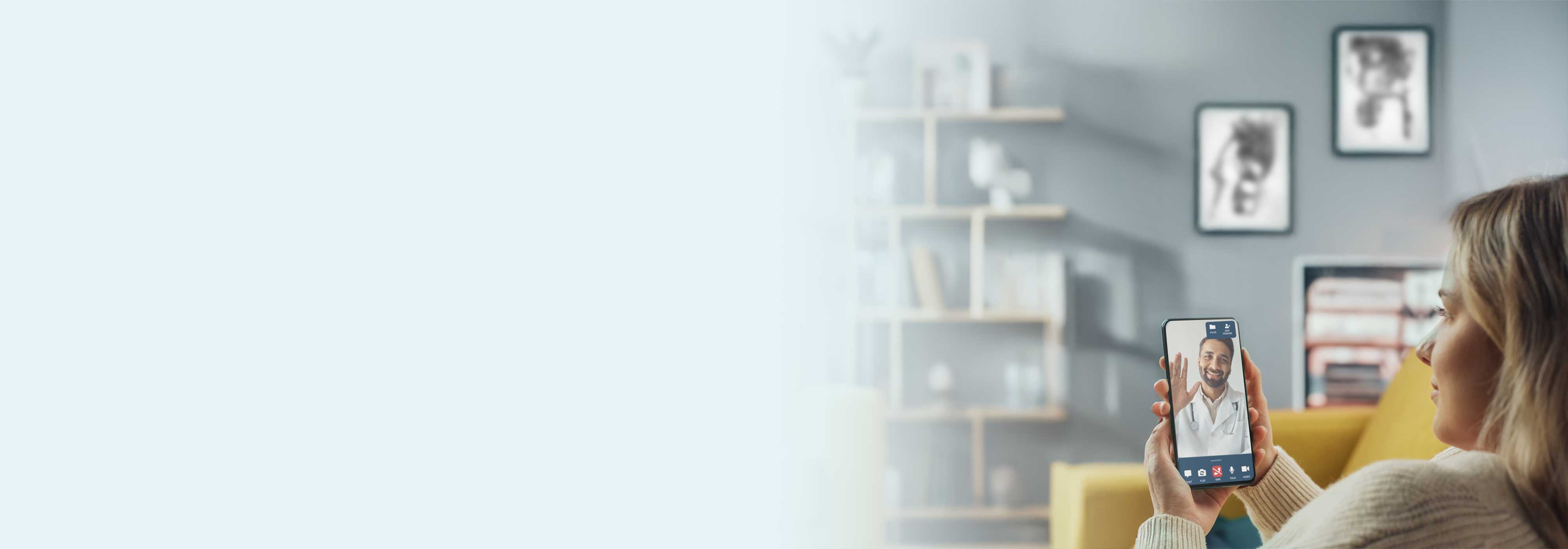 Woman sitting on yellow couch looking at phone with DialCare telemedicine visit.